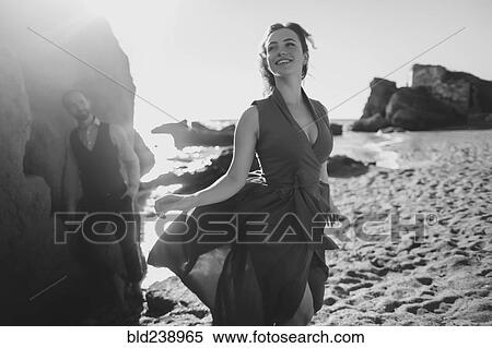 Stock Photography - Caucasian couple walking on beach. Fotosearch