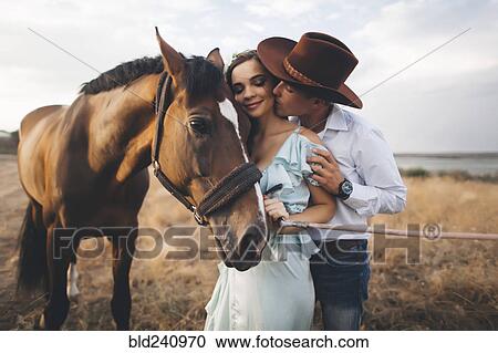Caucasian cowboy kissing woman on cheek near horse View Large Photo Image Stock Image - Caucasian cowboy kissing woman on cheek near horse. Fotosearch