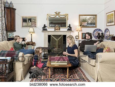 Caucasian family in livingroom View Large Photo Image Stock Photograph - Caucasian family in livingroom. Fotosearch