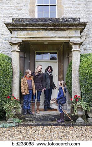 Caucasian family standing on front stoop View Large Photo Image Stock Photo - Caucasian family standing on front stoop. Fotosearch