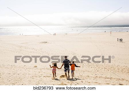 Caucasian family walking on beach View Large Photo Image Stock Image - Caucasian family walking on beach. Fotosearch