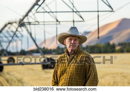 Caucasian farmer standing near irrigation equipment View Large Photo Image Stock Photograph - Caucasian farmer standing near irrigation equipment. Fotosearch