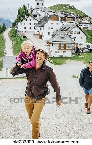 Stock Image - "Caucasian father carrying daughter, Tarvisio, Vienna, Austria". Fotosearch