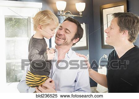 Stock Photography - Caucasian fathers comforting son. Fotosearch