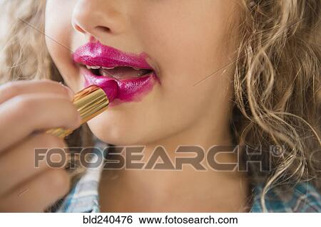 Caucasian girl applying messy lipstick View Large Photo Image Stock Photograph - Caucasian girl applying messy lipstick. Fotosearch