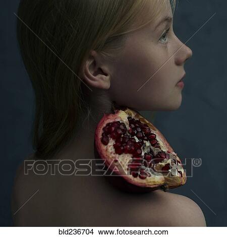 Caucasian girl balancing pomegranate slice on shoulder View Large Photo Image Picture - Caucasian girl balancing pomegranate slice on shoulder. Fotosearch