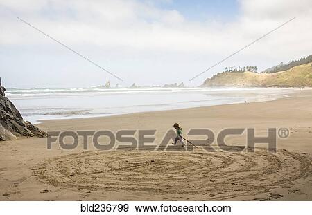 Caucasian girl drawing circles on beach with stick View Large Photo Image Stock Photo - Caucasian girl drawing circles on beach with stick. Fotosearch