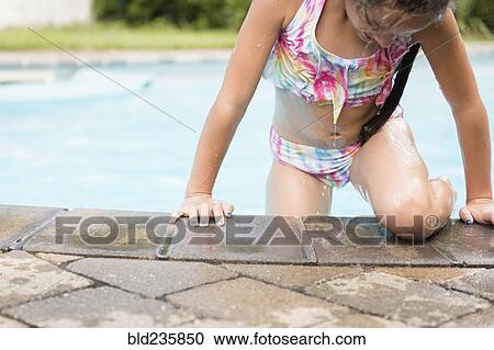 Caucasian girl exiting swimming pool View Large Photo Image Stock Image - Caucasian girl exiting swimming pool. Fotosearch