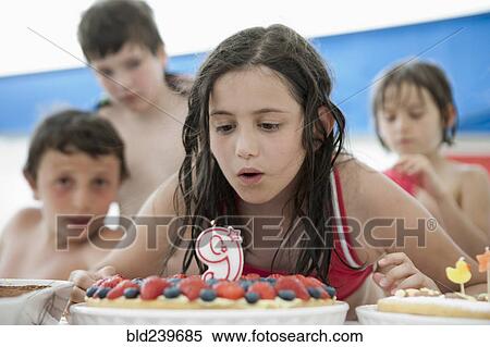 Caucasian girl extinguishing candle on birthday cake View Large Photo Image Stock Photography - Caucasian girl extinguishing candle on birthday cake. Fotosearch