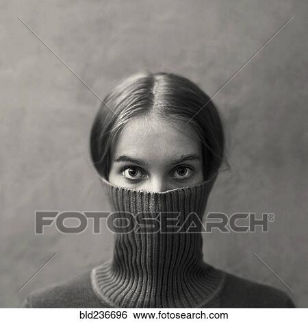 Caucasian girl hiding face in turtleneck View Large Photo Image Stock Photograph - Caucasian girl hiding face in turtleneck. Fotosearch