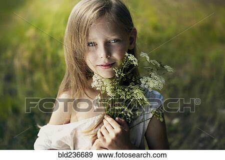 Caucasian girl holding bouquet of wildflowers View Large Photo Image Stock Photo - Caucasian girl holding bouquet of wildflowers. Fotosearch