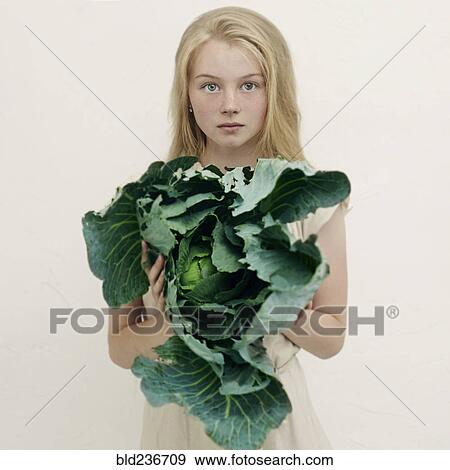 Caucasian girl holding leafy green lettuce View Large Photo Image Stock Photo - Caucasian girl holding leafy green lettuce. Fotosearch