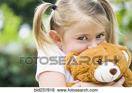 Caucasian girl hugging teddy bear View Large Photo Image Stock Photo - Caucasian girl hugging teddy bear. Fotosearch