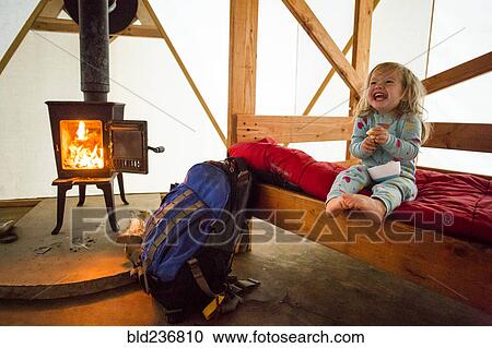 Caucasian girl laughing on bed in yurt View Large Photo Image Stock Image - Caucasian girl laughing on bed in yurt. Fotosearch