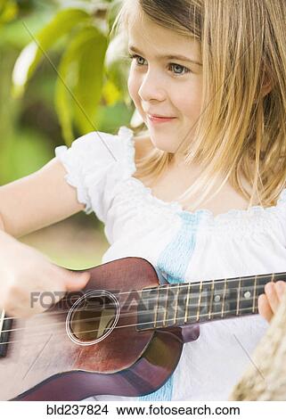 Caucasian girl playing ukulele View Large Photo Image Picture - Caucasian girl playing ukulele. Fotosearch
