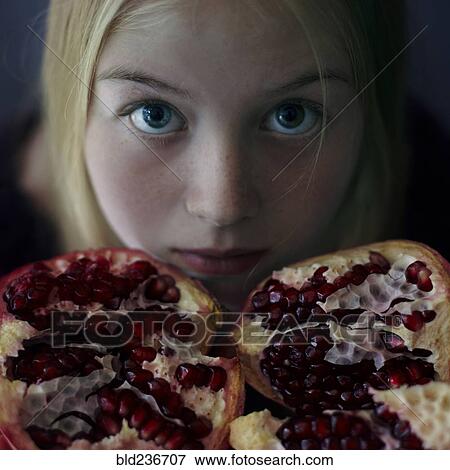 Caucasian girl showing pomegranate slices View Large Photo Image Stock Photo - Caucasian girl showing pomegranate slices. Fotosearch