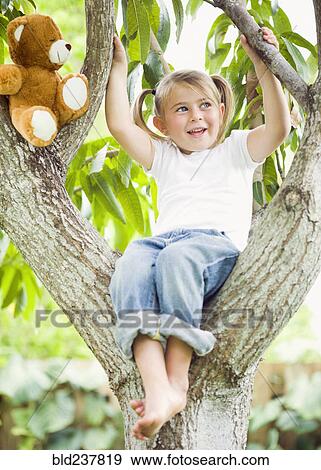 Caucasian girl sitting in tree with teddy bear View Large Photo Image Stock Photo - Caucasian girl sitting in tree with teddy bear. Fotosearch