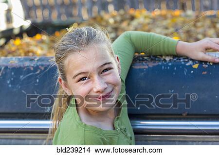 Caucasian girl smiling near autumn leaves in truck View Large Photo Image Picture - Caucasian girl smiling near autumn leaves in truck. Fotosearch