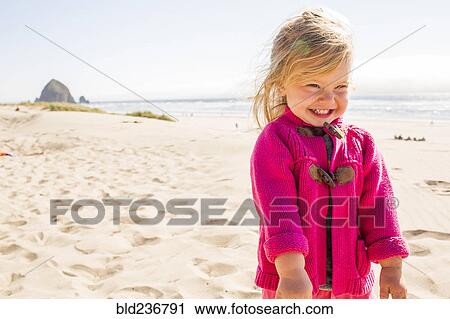Caucasian girl smiling on beach View Large Photo Image Stock Image - Caucasian girl smiling on beach. Fotosearch