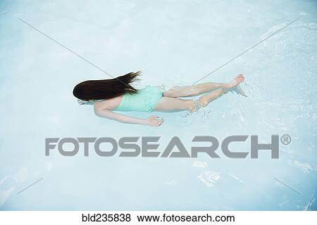 Caucasian girl swimming in swimming pool View Large Photo Image Stock Photo - Caucasian girl swimming in swimming pool. Fotosearch
