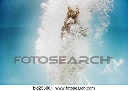 Caucasian girl swimming underwater holding nose View Large Photo Image Stock Image - Caucasian girl swimming underwater holding nose. Fotosearch