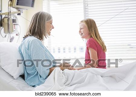 Caucasian granddaughter visiting with grandmother in hospital View Large Photo Image Stock Photography - Caucasian granddaughter visiting with grandmother in hospital. Fotosearch