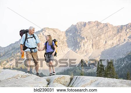 Caucasian grandfather and granddaughter hiking on mountain View Large Photo Image Stock Image - Caucasian grandfather and granddaughter hiking on mountain. Fotosearch