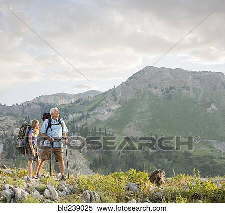 Caucasian grandfather and granddaughter hiking on mountain View Large Photo Image Stock Photography - Caucasian grandfather and granddaughter hiking on mountain. Fotosearch