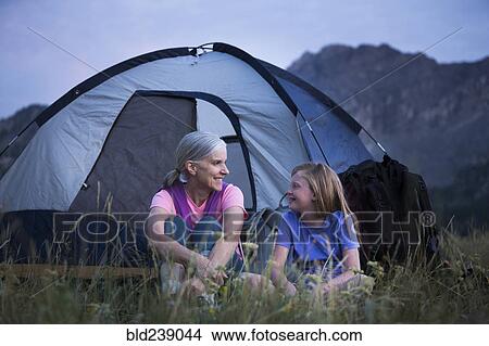 Caucasian grandmother and granddaughter camping on mountain View Large Photo Image Picture - Caucasian grandmother and granddaughter camping on mountain. Fotosearch