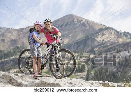 Caucasian grandmother and granddaughter posing with mountain bikes View Large Photo Image Stock Image - Caucasian grandmother and granddaughter posing with mountain bikes. Fotosearch