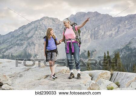 Caucasian grandmother and granddaughter hiking on mountain View Large Photo Image Stock Image - Caucasian grandmother and granddaughter hiking on mountain. Fotosearch