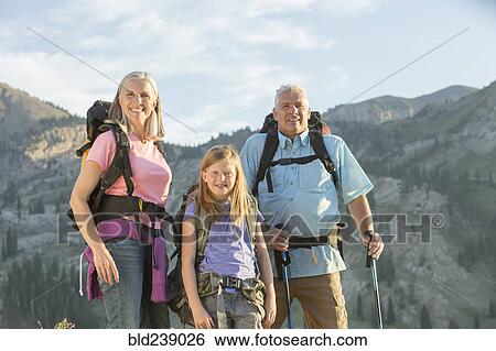 Caucasian grandparents and granddaughter hiking on mountain View Large Photo Image Stock Photograph - Caucasian grandparents and granddaughter hiking on mountain. Fotosearch