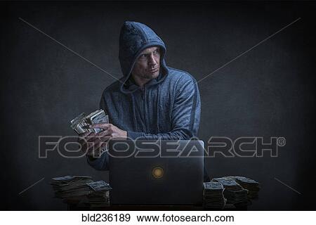 Stock Photo - Caucasian hacker stealing money from laptop. Fotosearch