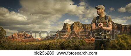 Caucasian hiker holding walking stick in desert landscape View Large Photo Image Stock Photograph - Caucasian hiker holding walking stick in desert landscape. Fotosearch