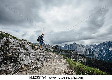 "Caucasian man admiring mountain range, Tarvisio, Vienna, Austria" View Large Photo Image Picture - "Caucasian man admiring mountain range, Tarvisio, Vienna, Austria". Fotosearch