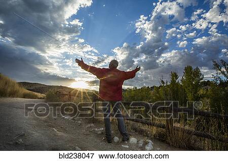 Caucasian man admiring sunset View Large Photo Image Stock Photo - Caucasian man admiring sunset. Fotosearch