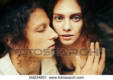 Stock Image - Caucasian man and woman hugging. Fotosearch