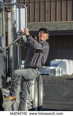 Caucasian man climbing into semi-truck View Large Photo Image Stock Image - Caucasian man climbing into semi-truck. Fotosearch