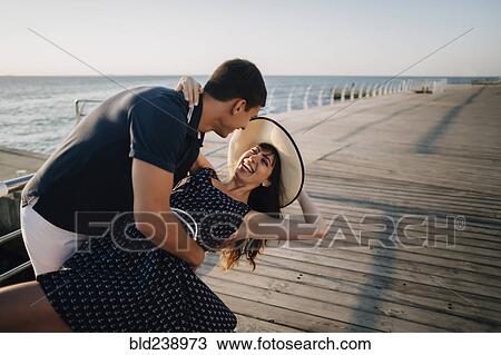 Caucasian man dipping woman at waterfront View Large Photo Image Stock Image - Caucasian man dipping woman at waterfront. Fotosearch