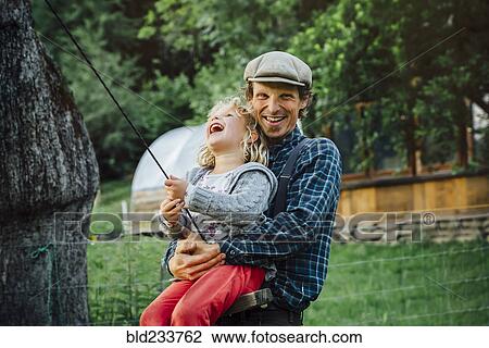 Caucasian man hugging daughter on rope swing View Large Photo Image Stock Image - Caucasian man hugging daughter on rope swing. Fotosearch