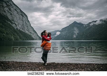 Caucasian man hugging near mountain lake View Large Photo Image Stock Image - Caucasian man hugging near mountain lake. Fotosearch