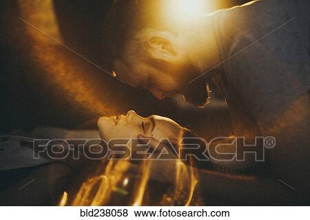 Stock Photo - Caucasian man leaning over face of woman. Fotosearch