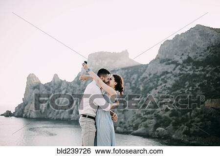 Caucasian man proposing marriage to woman at beach View Large Photo Image Stock Photograph - Caucasian man proposing marriage to woman at beach. Fotosearch