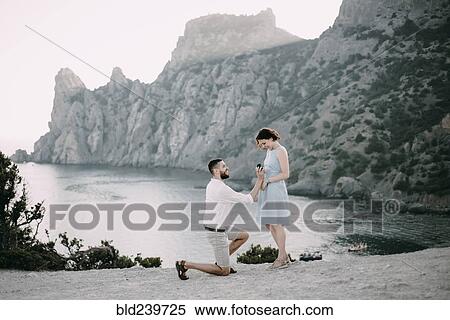 Caucasian man proposing marriage to woman at beach View Large Photo Image Stock Photography - Caucasian man proposing marriage to woman at beach. Fotosearch