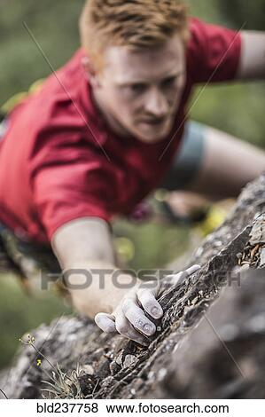 Caucasian man rock climbing View Large Photo Image Stock Photo - Caucasian man rock climbing. Fotosearch