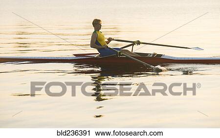 Caucasian man rowing on lake View Large Photo Image Stock Image - Caucasian man rowing on lake. Fotosearch
