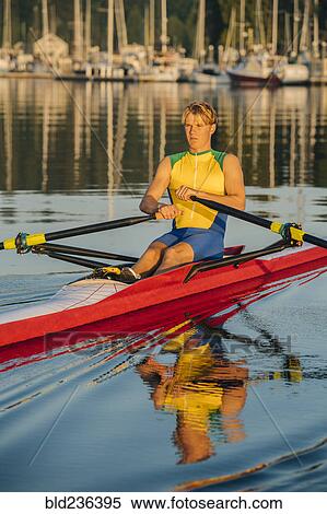 Caucasian man rowing on lake View Large Photo Image Stock Photography - Caucasian man rowing on lake. Fotosearch