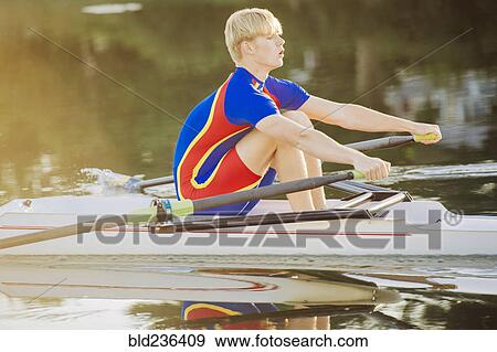 Caucasian man rowing on river View Large Photo Image Stock Photo - Caucasian man rowing on river. Fotosearch