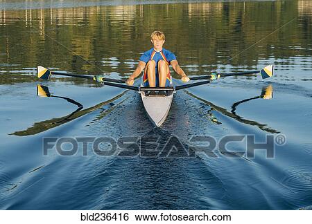 Caucasian man rowing on river View Large Photo Image Stock Photograph - Caucasian man rowing on river. Fotosearch