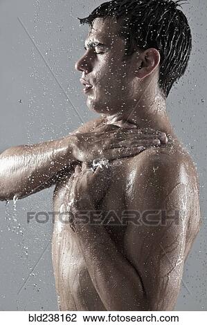 Stock Image - Caucasian man showering. Fotosearch